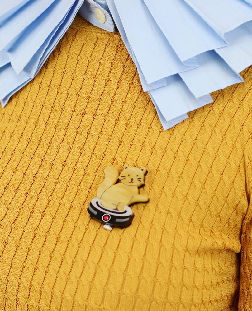 Cat riding a robot vacuum brooch