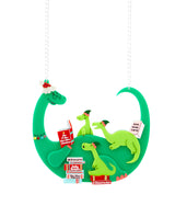 Jolly Granny Dino-Claus reading to her Grand-Elf-Dinos Necklace
