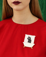Murder in the shower brooch